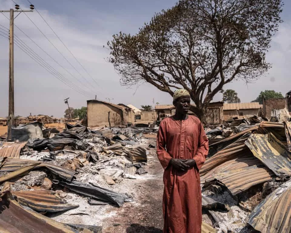 A resident stands among burnt debris and damaged homes after the attack in Woro, Kwara state, on February 5, 2026.Photograph: Light Oriye Tamunotonye/AFP/Getty Images