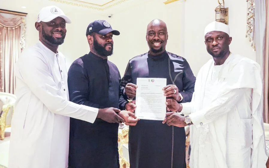 President Tinubu's son, Seyi Tinubu, presenting businessman and socialite Obinna “Obi Cubana” Iyiegbu an appointment letter as South-East Director of the City Boy Movement (CBM), a youth-driven support group for the President's re-election campaign