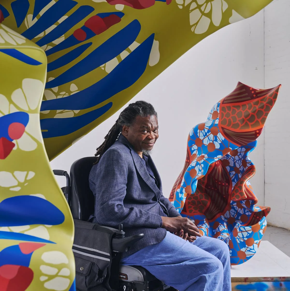 Yinka Shonibare, known for his spotlight on Dutch wax fabrics, amid two of his sculptural creations in London. (Photo: NYTimes)